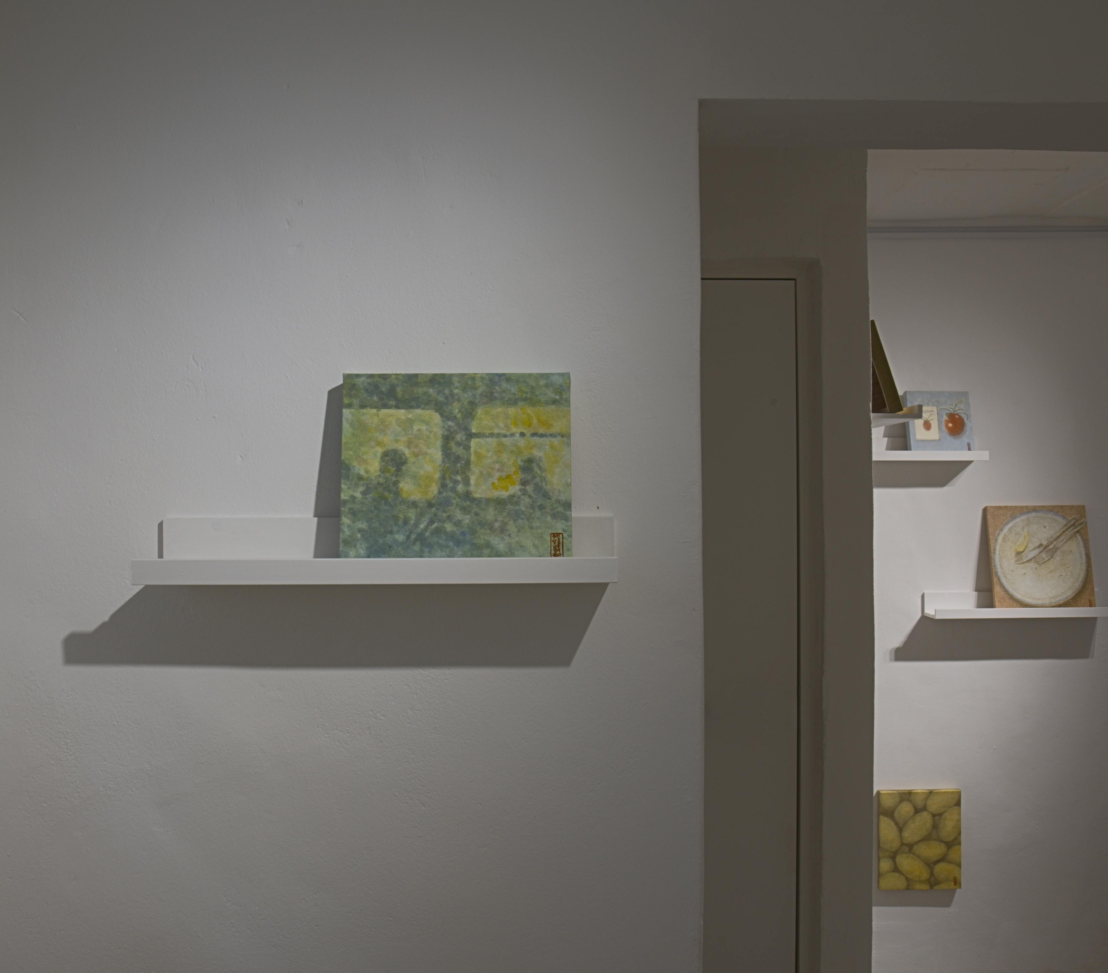 A Meal for Two installation view with paintings on gallery shelves