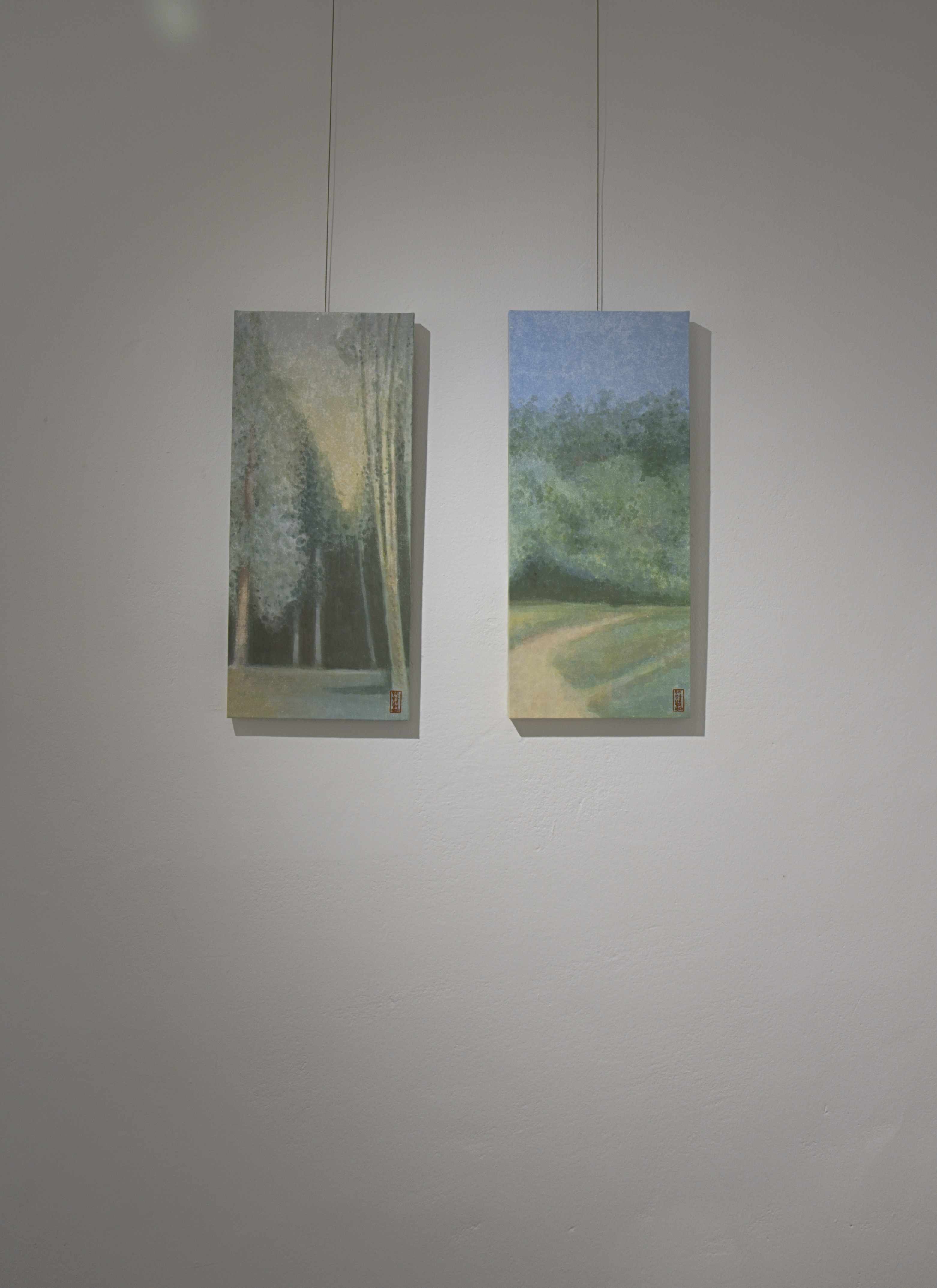 A Meal for Two installation view with paintings on a gallery wall