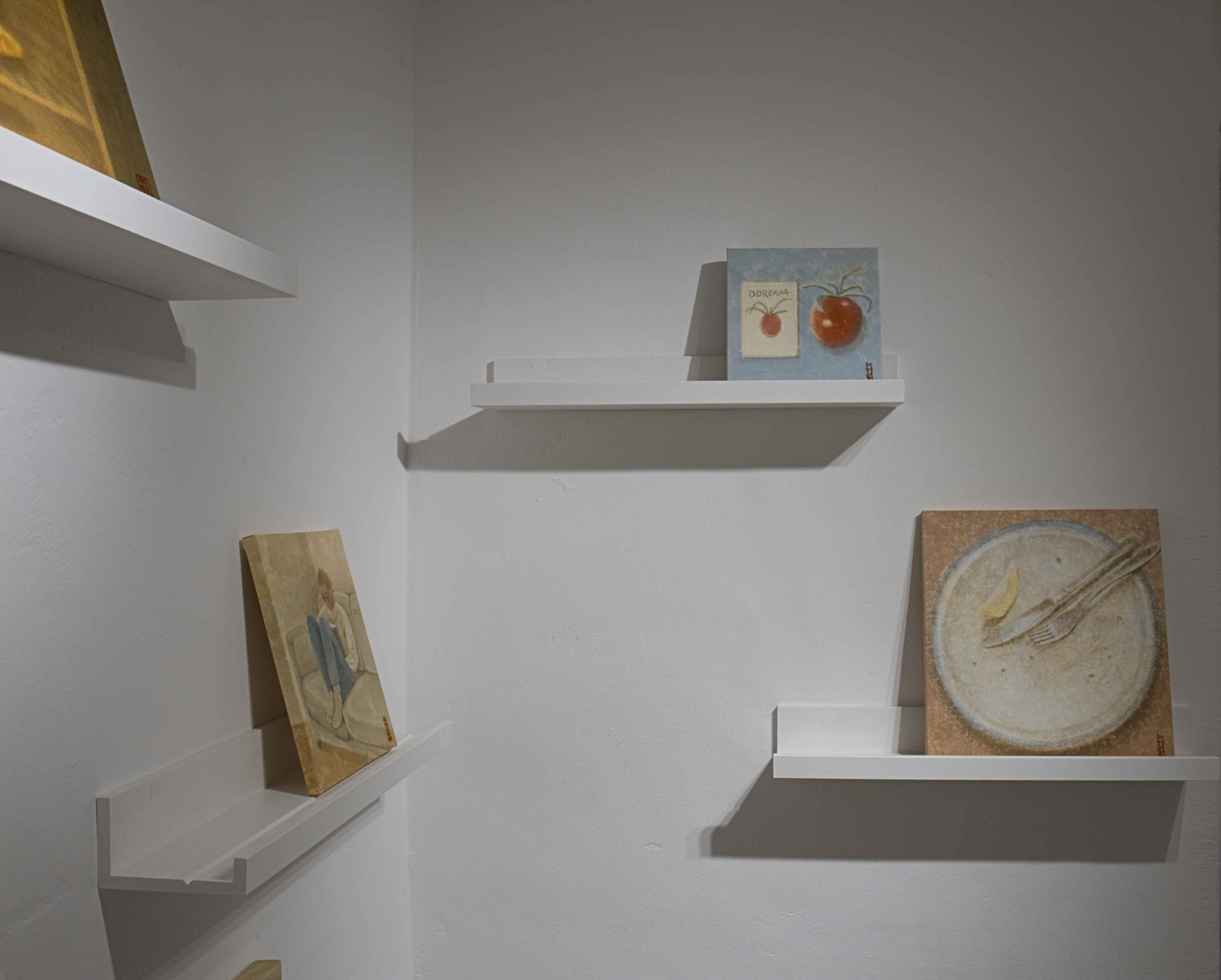 A Meal for Two close installation view with paintings on shelves